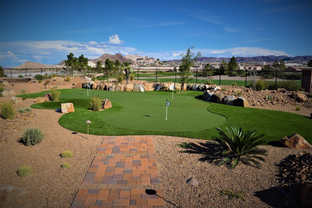A golf course with a putting green and brick path. A golf course with a putting green and brick path.